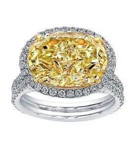 A diamond ring with a yellow center stone.