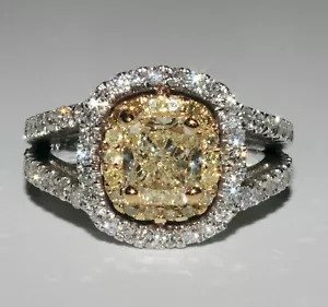 A diamond ring with a yellow center stone.