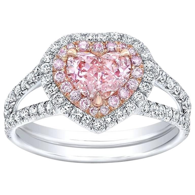 A pink diamond heart shaped ring with white and rose gold accents.