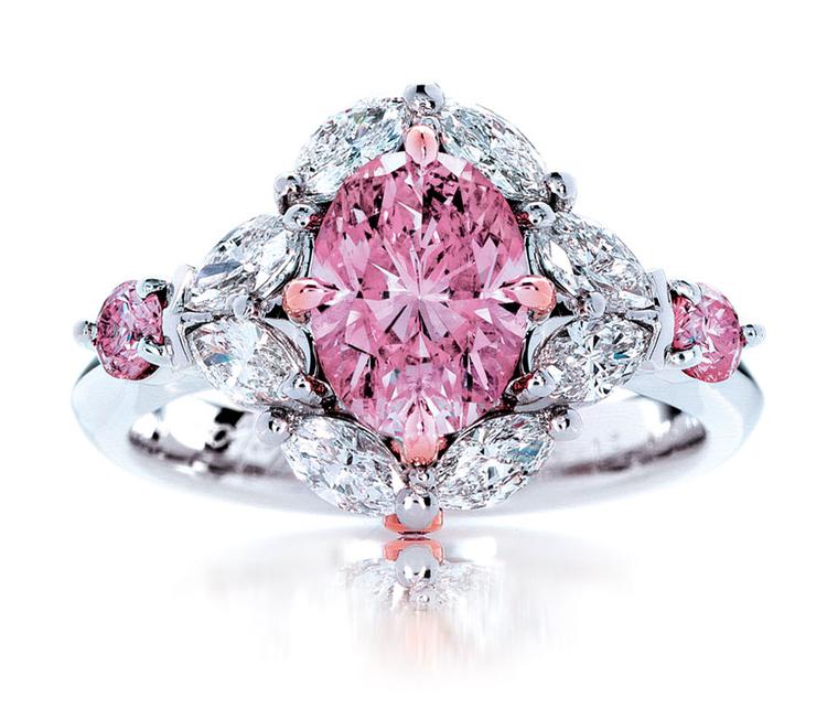 A pink diamond ring with white and pink diamonds.