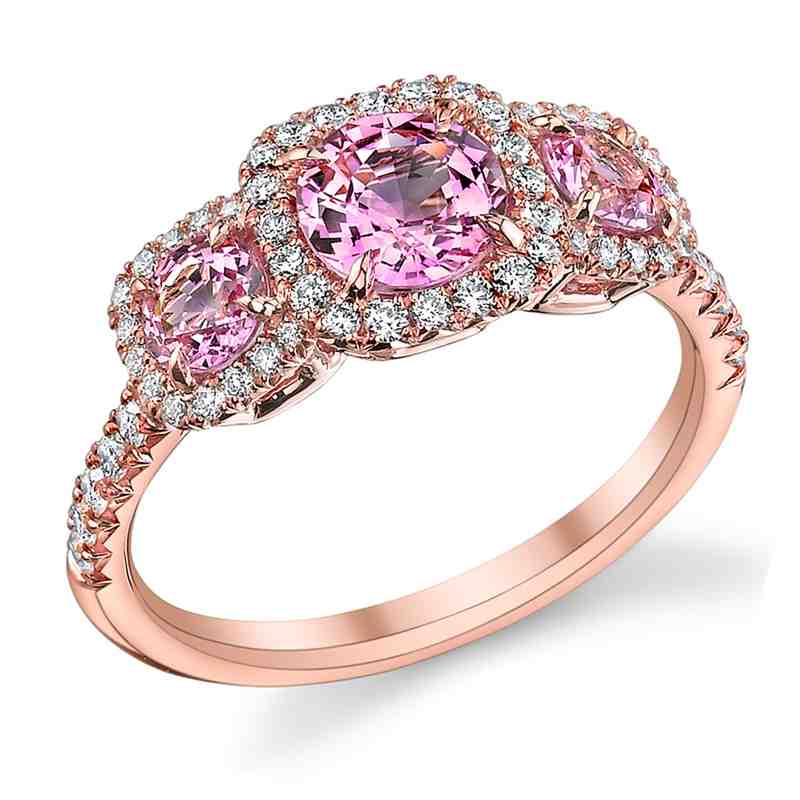 A pink diamond ring with three round diamonds on each side.