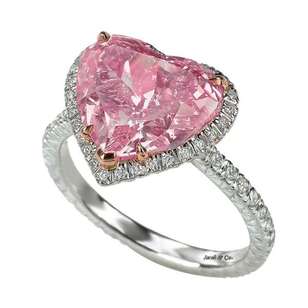 A pink heart shaped diamond ring with white and rose gold accents.