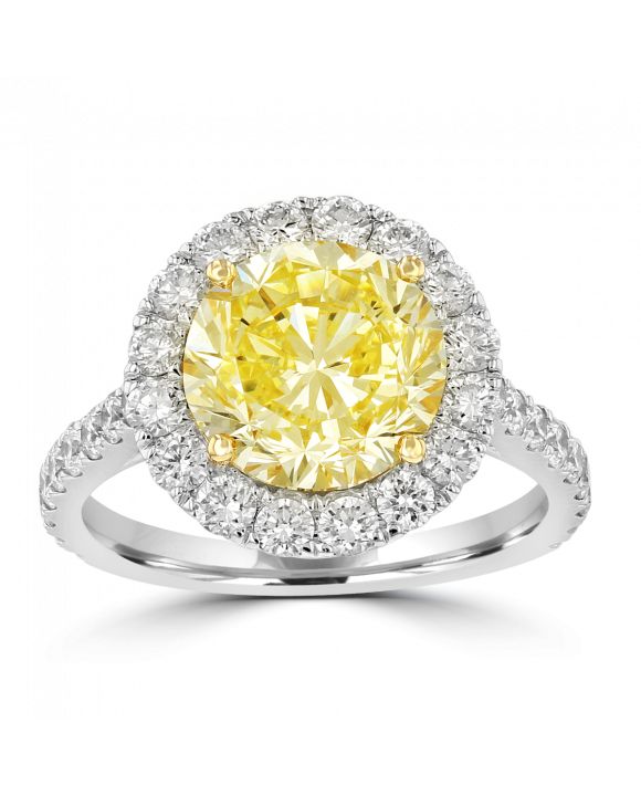 A yellow diamond ring with white diamonds around it.